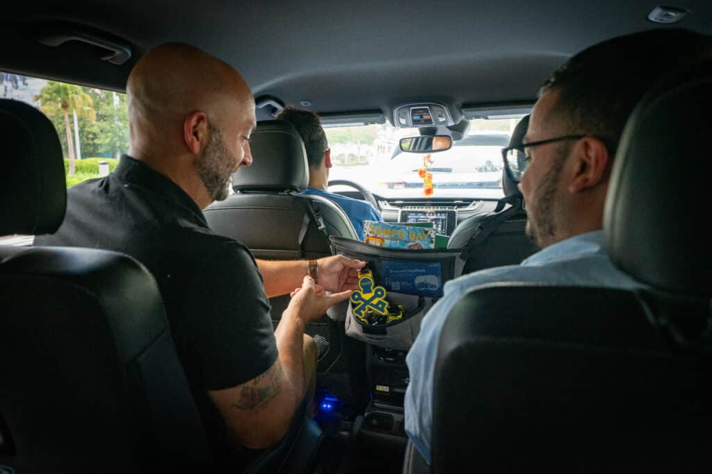 DI Attendees enjoy free swag offered in the back of a Visit Tampa Bay-branded vehicle.
